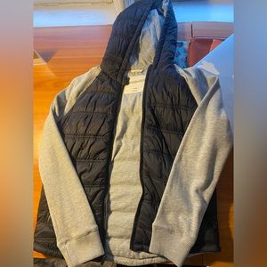 Black puffer jacket with sweatshirt hood and sleeves